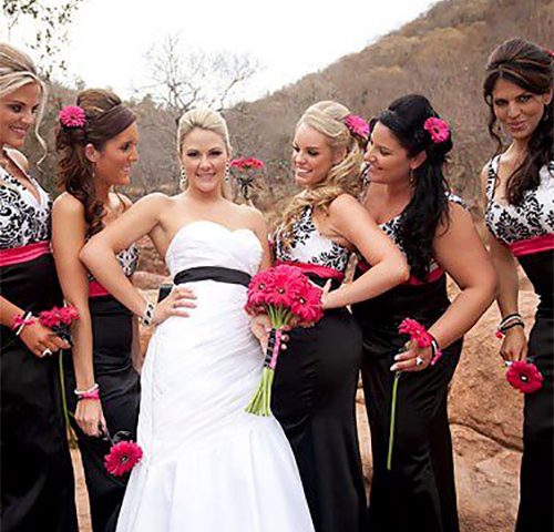 One Bride in white surrounded by five bridesmaids in black on wedding day